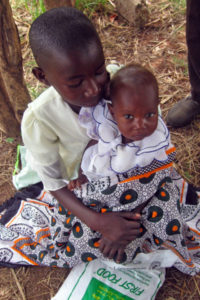 Kenyan child wiith baby