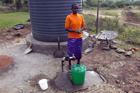 Kenyan Man at water tank